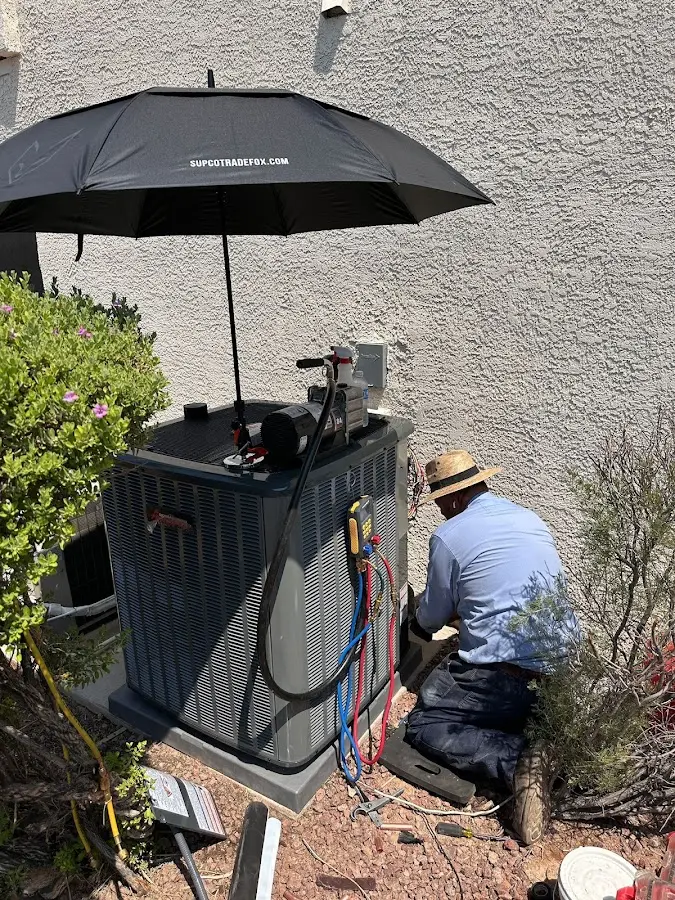 HVAC technician performing outdoor AC maintenance in Ormond Beach